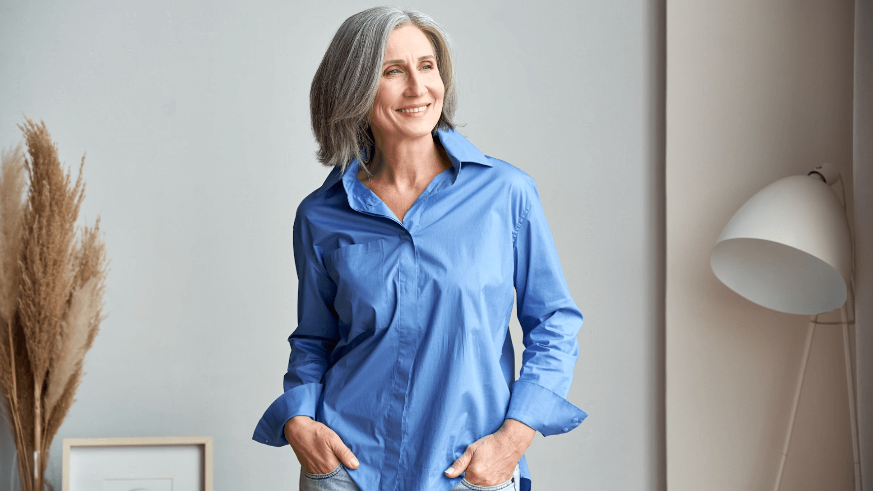 older woman smiling with hands